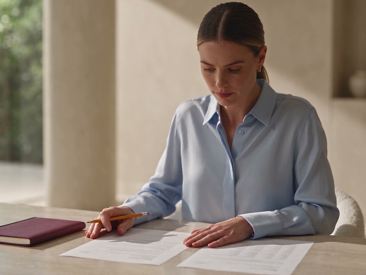 A finance coordinator compares an invoice item with a cost sheet