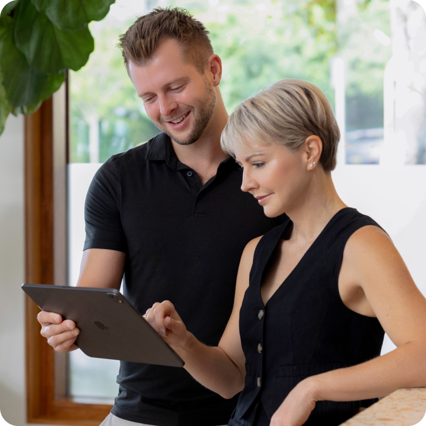Luke Fuller and Suzie Hoitink reviewing a tablet together.
