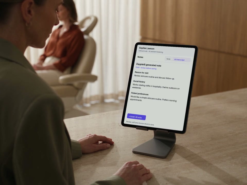 A practitioner listens to a patient in an aesthetic consultation, with DappleOS on a supported iPad.
