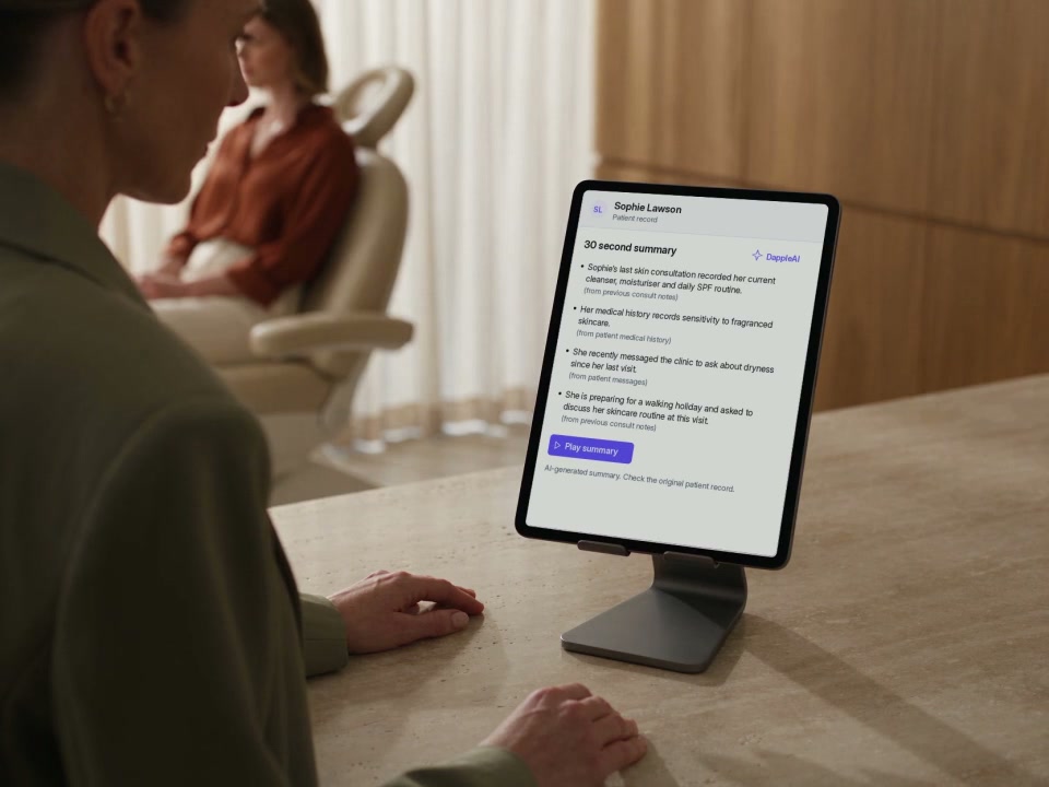 A practitioner reviews a sourced patient summary on an iPad before turning to the patient.