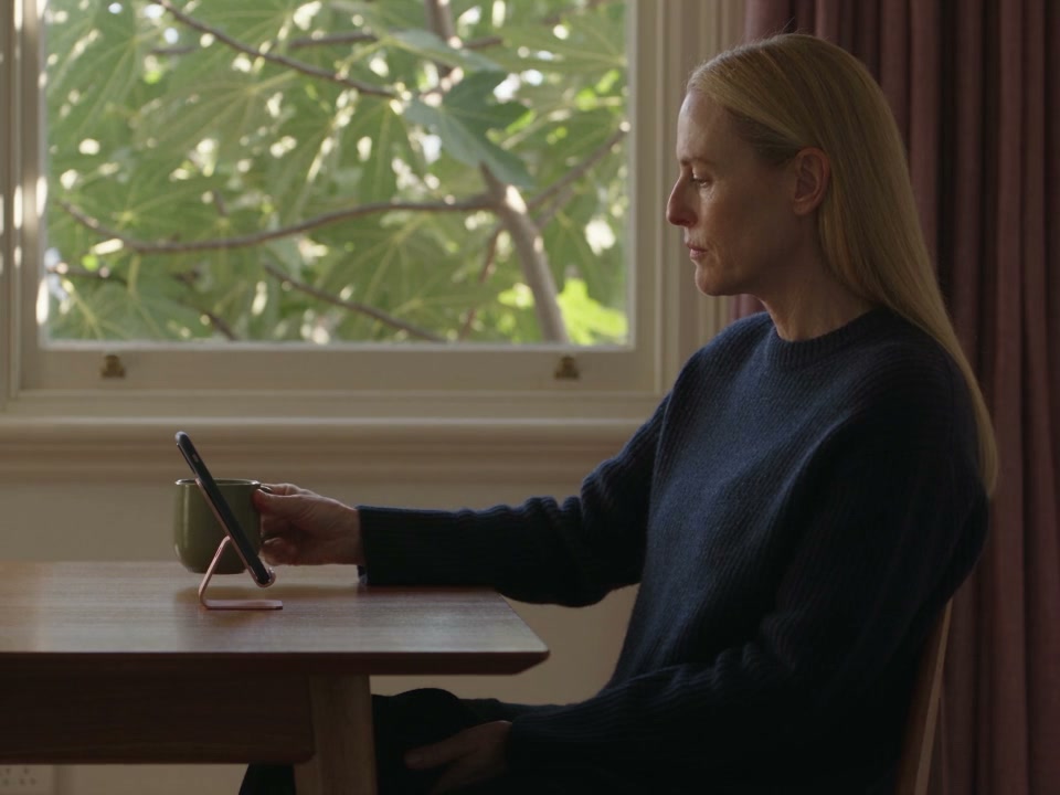 A patient checks their phone at home