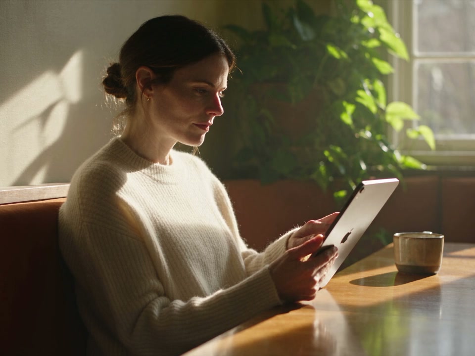 A patient takes a quiet moment to read a clinic email on a tablet at home