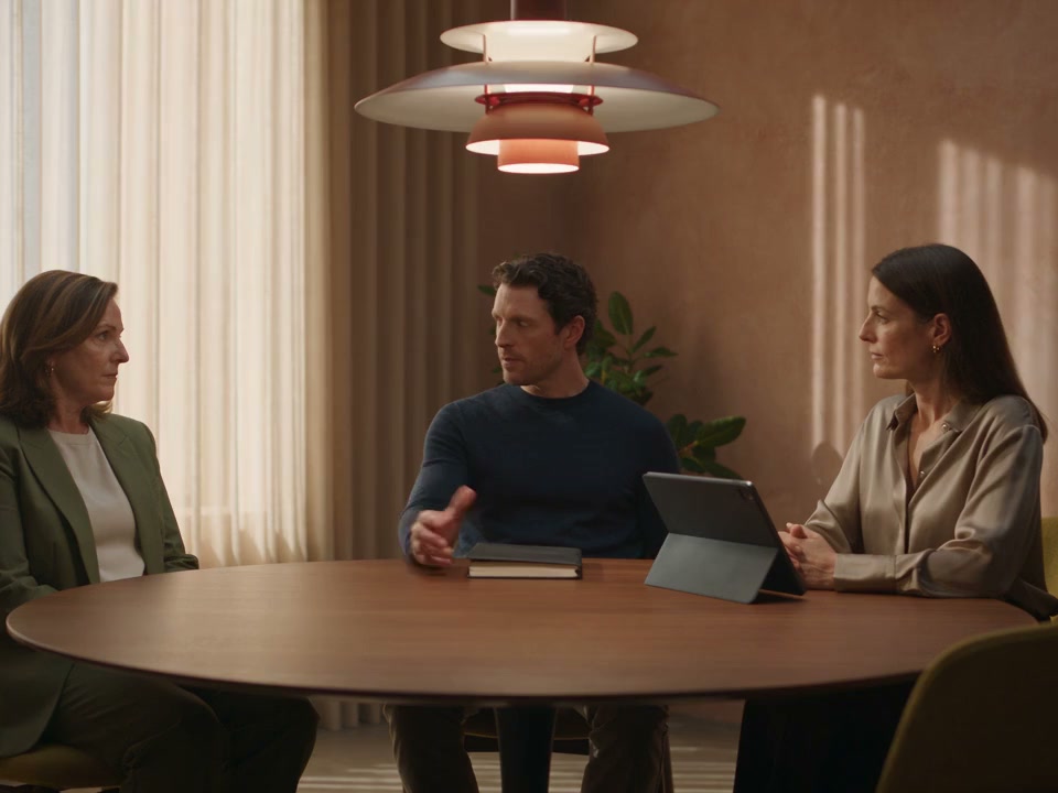 Clinic colleagues discussing their work together in a meeting room