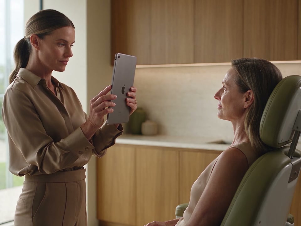 A practitioner taking a patient’s clinical photograph with an iPad